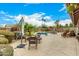 Inviting backyard with a pool, patio seating and lush desert landscaping for relaxing and entertaining at 10971 W Tonopah Dr, Peoria, AZ 85373