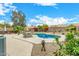 Backyard featuring a kidney-shaped pool, lush landscaping, and patio seating for relaxation and entertaining at 10971 W Tonopah Dr, Peoria, AZ 85373