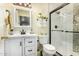 Bathroom features a shower with a glass door, vanity, mirror, sink, and toilet at 10971 W Tonopah Dr, Peoria, AZ 85373