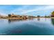 A beautiful lake bordered by homes, promoting a peaceful community atmosphere and waterside living at 10971 W Tonopah Dr, Peoria, AZ 85373