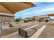 Horseshoe pits adjacent to homes featuring shaded seating at 10971 W Tonopah Dr, Peoria, AZ 85373