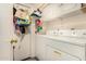 The Laundry Room features white appliances and shelving, offering a space-saving solution for organization at 10971 W Tonopah Dr, Peoria, AZ 85373