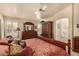 Large main bedroom with a ceiling fan, plush carpet, and stylish furnishings at 10971 W Tonopah Dr, Peoria, AZ 85373