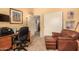Home office with comfortable seating, personal decor, access to storage, and vinyl flooring at 10971 W Tonopah Dr, Peoria, AZ 85373