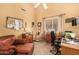 Home office with comfortable seating, personal decor, window and plenty of natural light at 10971 W Tonopah Dr, Peoria, AZ 85373