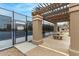 View of a tennis court with rules sign and a covered picnic area with a stone picnic table at 10971 W Tonopah Dr, Peoria, AZ 85373