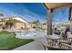 Inviting backyard oasis with a swimming pool, patio furniture, and a grill at 11332 E Des Moines Cir, Mesa, AZ 85207