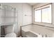 Bathroom with bathtub, toilet, and window at 11411 N 91 Ave # 56, Peoria, AZ 85345
