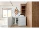 Bathroom with pedestal sink, washer, dryer, and built-in shelving at 11411 N 91 Ave # 56, Peoria, AZ 85345