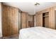 Bedroom with wood paneled walls and a double bed at 11411 N 91 Ave # 56, Peoria, AZ 85345