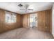 Bedroom with ceiling fan, wood-paneled walls and carpet at 11411 N 91 Ave # 56, Peoria, AZ 85345
