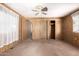 Spacious bedroom with ceiling fan, wood-paneled walls, and large closet at 11411 N 91 Ave # 56, Peoria, AZ 85345