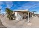 Tan mobile home with carport, and paved driveway at 11411 N 91 Ave # 56, Peoria, AZ 85345