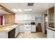 Bright kitchen with white cabinets, gas range, and dishwasher at 11411 N 91 Ave # 56, Peoria, AZ 85345