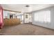 Living room with wood paneling, carpet, and kitchen bar at 11411 N 91 Ave # 56, Peoria, AZ 85345
