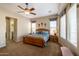 Bright bedroom with wooden furniture and large windows at 13050 W Pinnacle Vista Dr, Peoria, AZ 85383