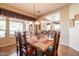 Bright dining room with stone top table and view into kitchen at 13050 W Pinnacle Vista Dr, Peoria, AZ 85383