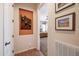 Hallway with artwork and a view into a bedroom at 13050 W Pinnacle Vista Dr, Peoria, AZ 85383