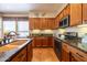 Kitchen with double sink, granite counters and wood cabinets at 13050 W Pinnacle Vista Dr, Peoria, AZ 85383