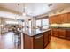 Kitchen island with breakfast bar, granite counters, and stainless steel appliances at 13050 W Pinnacle Vista Dr, Peoria, AZ 85383