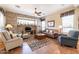 Spacious living room with stone fireplace and comfortable seating at 13050 W Pinnacle Vista Dr, Peoria, AZ 85383