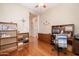 Home office with wood desk, built-in shelves, and hardwood floors at 13050 W Pinnacle Vista Dr, Peoria, AZ 85383
