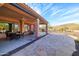 Covered patio with stone flooring, seating area, and mountain views at 13050 W Pinnacle Vista Dr, Peoria, AZ 85383