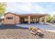 Large covered patio with flagstone and desert landscape at 13050 W Pinnacle Vista Dr, Peoria, AZ 85383