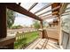 Relaxing balcony offers a pergola, iron railing, and views of the nearby street and landscaping at 14250 W Wigwam Blvd # 2822, Litchfield Park, AZ 85340