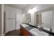 Bright bathroom with double sinks, vanity, and tiled shower and floors at 14250 W Wigwam Blvd # 2822, Litchfield Park, AZ 85340
