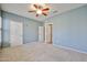 Carpeted bedroom with fan and an open doorway, offering a spacious feel at 14250 W Wigwam Blvd # 2822, Litchfield Park, AZ 85340