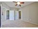 Spacious bedroom with carpeting, ceiling fan, and multiple doors for easy access at 14250 W Wigwam Blvd # 2822, Litchfield Park, AZ 85340