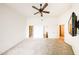 Neutral bedroom shows ceiling fan, access to closet, ensuite bathroom, and television on wall at 14250 W Wigwam Blvd # 2822, Litchfield Park, AZ 85340