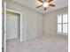 Beige bedroom with plush carpeting, a ceiling fan, and a window at 14250 W Wigwam Blvd # 2822, Litchfield Park, AZ 85340