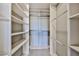 Walk-in closet with built-in shelving and racks, offering ample storage space at 14250 W Wigwam Blvd # 2822, Litchfield Park, AZ 85340