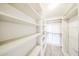 Bright, walk-in closet provides ample storage with built-in shelving and hanging rods at 14250 W Wigwam Blvd # 2822, Litchfield Park, AZ 85340