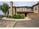 Inviting two-story townhome featuring a private balcony, attached garage, and beautifully landscaped front yard at 14250 W Wigwam Blvd # 2822, Litchfield Park, AZ 85340