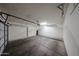 Spacious garage with ample room for parking, equipped with overhead storage racks at 14250 W Wigwam Blvd # 2822, Litchfield Park, AZ 85340