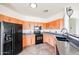 Well-lit kitchen features wooden cabinets, granite countertops, stainless steel appliances, and tile flooring at 14250 W Wigwam Blvd # 2822, Litchfield Park, AZ 85340