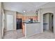 Functional kitchen featuring black appliances and ample counter space, open to a carpeted room at 14250 W Wigwam Blvd # 2822, Litchfield Park, AZ 85340