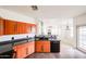 The modern kitchen with wood cabinets, dark countertops, and stainless steel appliances has an open-concept view at 14250 W Wigwam Blvd # 2822, Litchfield Park, AZ 85340