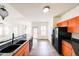 Bright kitchen featuring dark countertops and modern appliances with an open-concept view to the living area at 14250 W Wigwam Blvd # 2822, Litchfield Park, AZ 85340