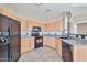 Well-equipped kitchen with sleek black appliances and light wood cabinetry at 14250 W Wigwam Blvd # 2822, Litchfield Park, AZ 85340