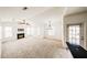 Open-concept living room with carpet, a fireplace, many windows, a ceiling fan, and a chandelier at 14250 W Wigwam Blvd # 2822, Litchfield Park, AZ 85340