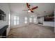 Cozy living room featuring a ceiling fan, natural light, and neutral paint scheme at 14250 W Wigwam Blvd # 2822, Litchfield Park, AZ 85340