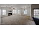 Bright living room featuring large windows, modern lighting, and a cozy fireplace at 14250 W Wigwam Blvd # 2822, Litchfield Park, AZ 85340