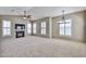 Bright, open living room featuring a fireplace, ceiling fan, and many shuttered windows at 14250 W Wigwam Blvd # 2822, Litchfield Park, AZ 85340