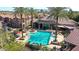 Aerial view of community pool and gathering area with resort-style seating and lush landscaping at 14250 W Wigwam Blvd # 2822, Litchfield Park, AZ 85340
