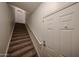 Carpeted stairway with white doors offering a warm welcome at 14250 W Wigwam Blvd # 2822, Litchfield Park, AZ 85340