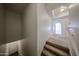 Carpeted stairs lead to a bright hallway, showcasing neutral tones and modern design at 14250 W Wigwam Blvd # 2822, Litchfield Park, AZ 85340